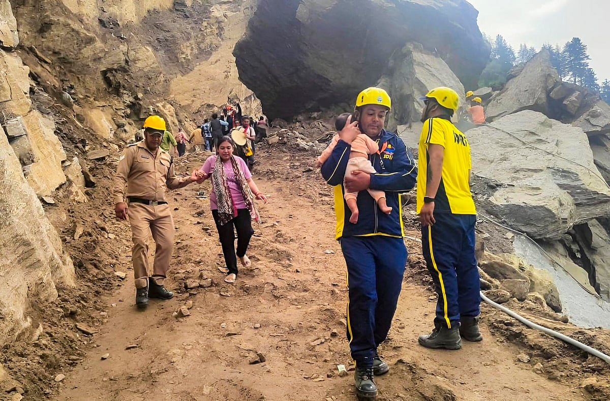 PTI : SDRF personnel assist people to cross the landslide-hit Jogidhara area along the Badrinath National Highway, in Chamoli district, July 11, 2024.